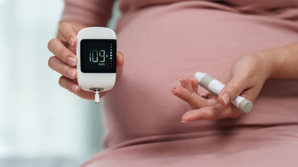 Pregnant woman checking blood sugar levels with a glucometer